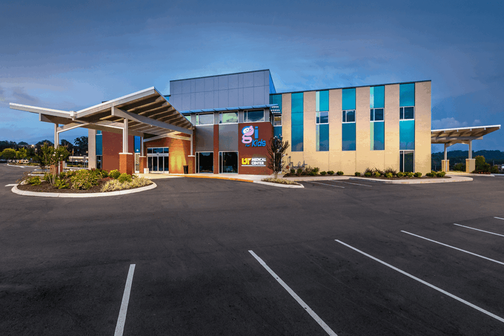 Modern medical center exterior featuring colorful design elements and a covered entrance, showcasing GAE Architecture + Design's work as commercial architects in Knoxville, TN.