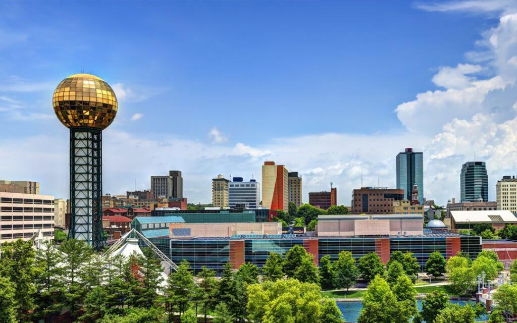 Knoxville skyline featuring the iconic Sunsphere, a symbol of GAE Architecture + Design, with urban buildings and greenery in the foreground.