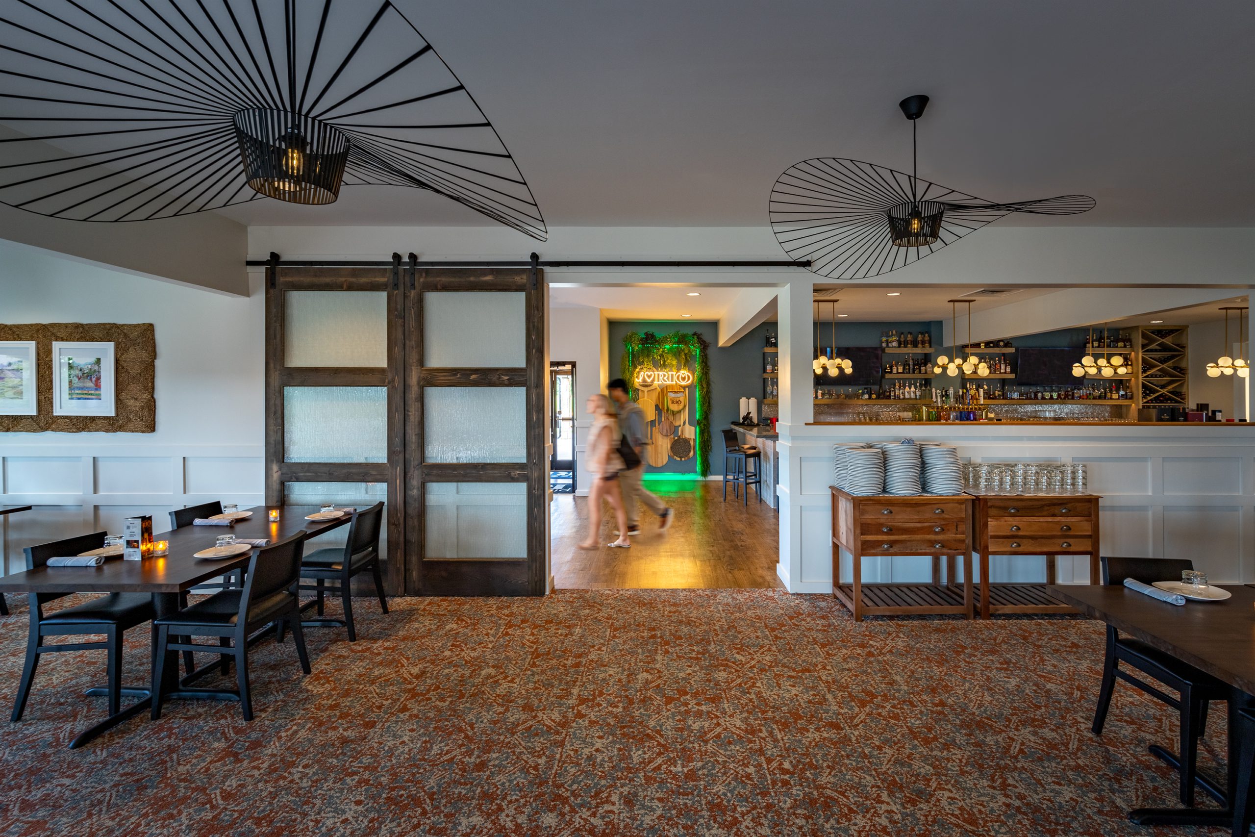 Interior view of Pizza Rio restaurant in Pigeon Forge, showcasing vaulted wood ceiling, stylish lighting fixtures, and an inviting dining area designed by GAEA, a top commercial architect firm in Knoxville, TN.
