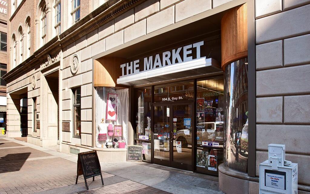 Commercial building exterior featuring "THE MARKET" storefront, showcasing adaptive reuse design by GAE Architecture + Design, located at 504 S. Gay St. in Knoxville, TN.