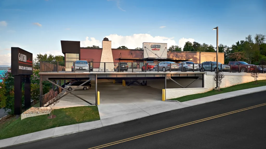 Gaucho Urbano Brazilian steakhouse in Pigeon Forge, featuring a two-story parking garage integrated into the hillside, designed and built by George Ewart, a top commercial architect firm in Knoxville, TN.
