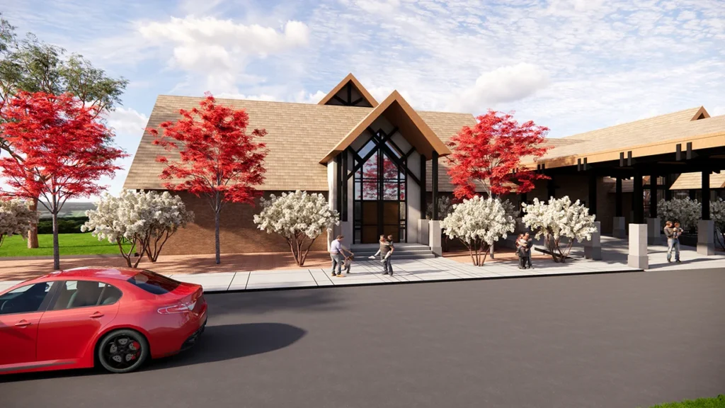 New Family Life Center at St. Joseph the Worker Catholic Church, featuring modern architecture, red and white flowering trees, and parishioners interacting outside, designed and built by George Ewart, a top commercial architect firm in Knoxville, TN.