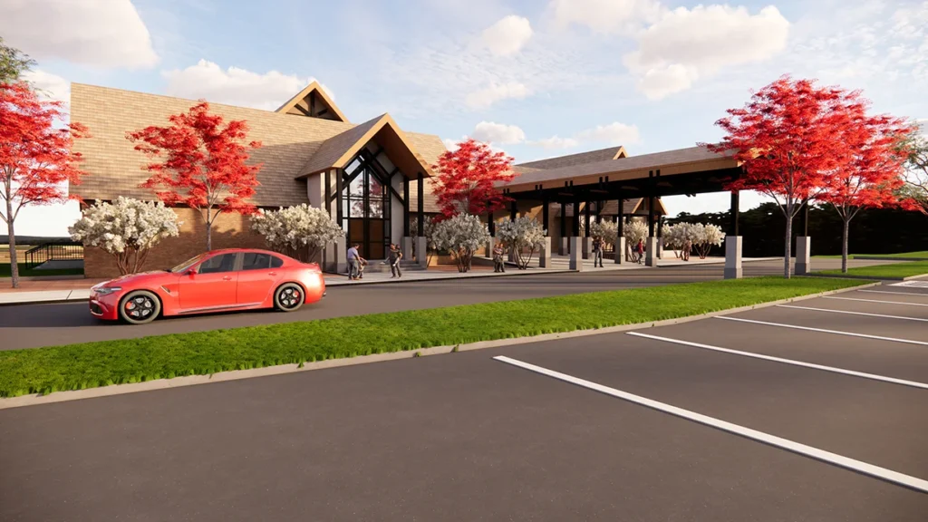Rendering of St. Joseph the Worker Catholic Church's new Family Life Center, featuring a modern design with a covered drop-off area, vibrant red trees, and a parking lot, designed and built by George Ewart, a top commercial architect firm in Knoxville, TN.