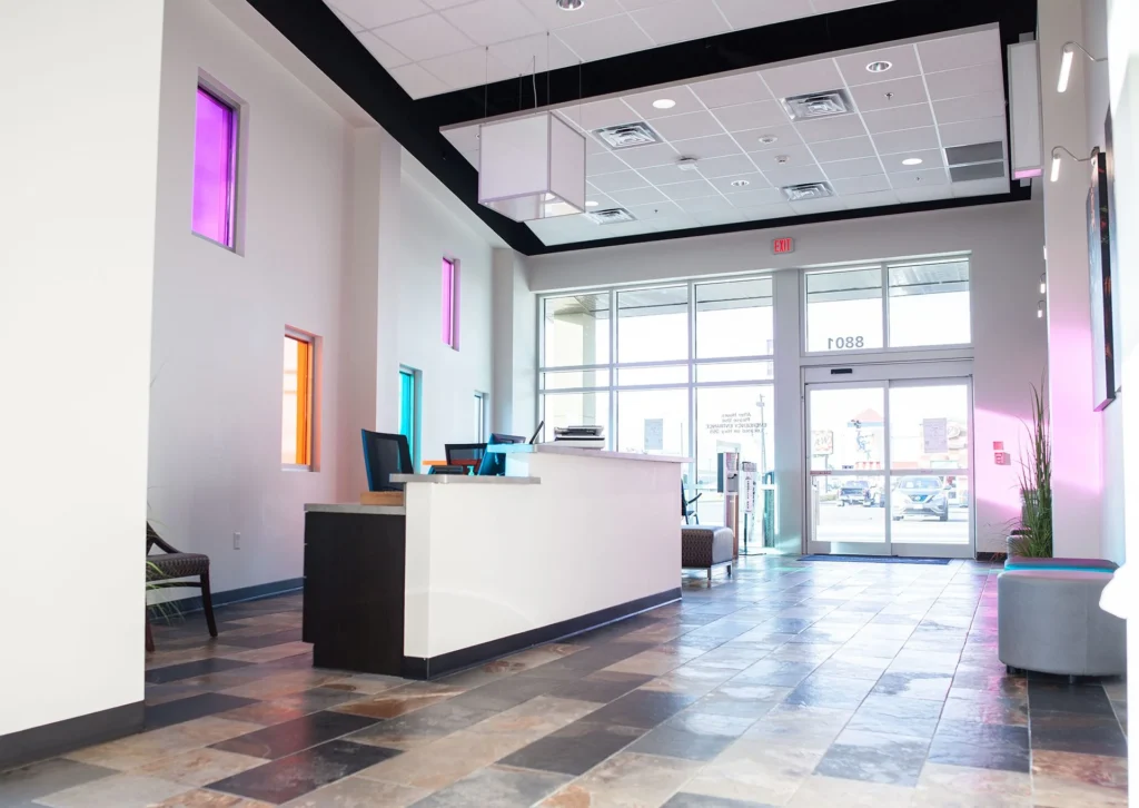 Reception area of CHRISTUS Health St. Mary’s Outpatient Center featuring a modern design with colorful windows, a welcoming front desk, and spacious layout, emphasizing accessibility and healthcare services in Port Arthur, Texas, designed and built by George Ewart, a top commercial architect firm in Knoxville, TN.