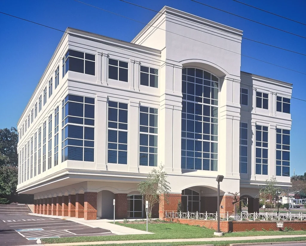 Meridian Building, a renovated professional office structure in Knoxville, TN, featuring a modern exterior design with large windows, brick accents, and a small plaza for sculpture display, designed and built by George Ewart, a top commercial architect firm in Knoxville, TN.
