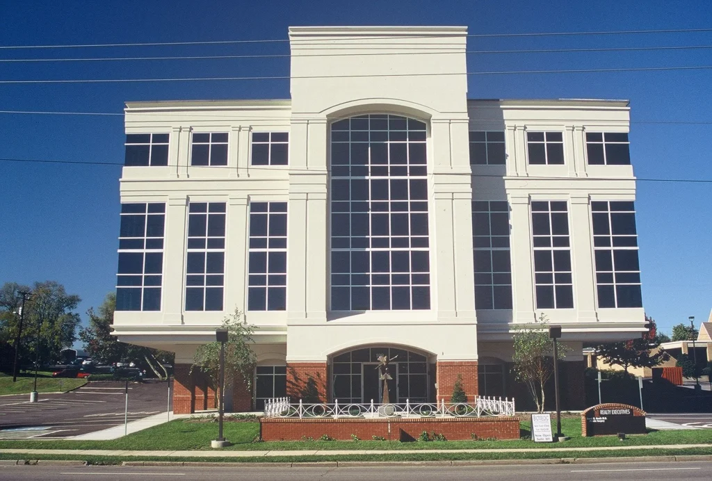 Meridian Building in Knoxville, TN, featuring a modern exterior renovation with large windows, brick accents, and landscaped plaza, designed and built by George Ewart, a top commercial architect firm in Knoxville, TN.