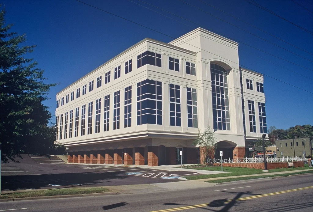 Modern professional office building at Northshore Plaza in Knoxville, TN, featuring a renovated exterior with large windows, brick accents, and a small plaza displaying a sculpture, designed and built by George Ewart, a top commercial architect firm in Knoxville, TN.