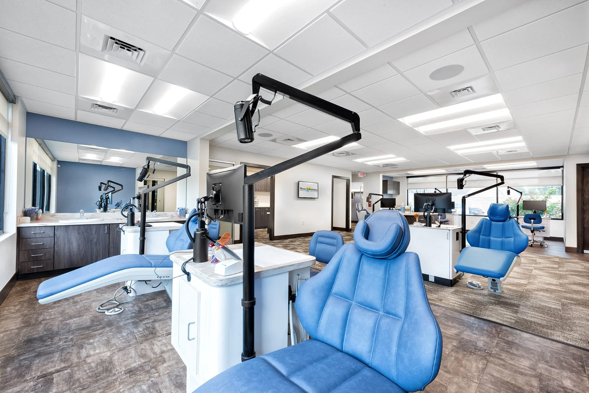 Modern orthodontic office interior featuring blue dental chairs, treatment stations, and advanced equipment, designed for improved functionality and patient experience at Myers Orthodontics in Knoxville, Tennessee.
