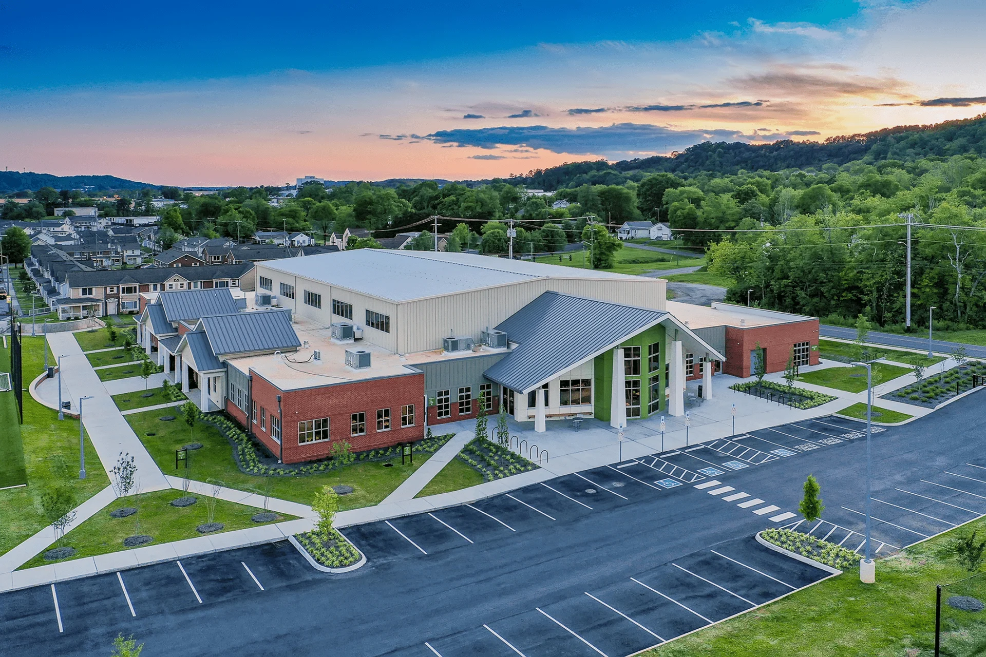 Emerald Youth Foundation community center in Knoxville, TN, featuring modern architecture, landscaped pathways, and surrounding greenery, designed and built by George Ewart, a top commercial architect firm in Knoxville, TN.