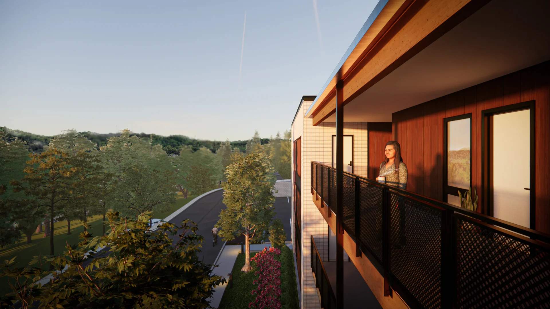 Woman on balcony of modern residential building at Historic Giffin Square, showcasing adaptive reuse in South Knoxville, TN, with surrounding greenery and thoughtful design by commercial architects.