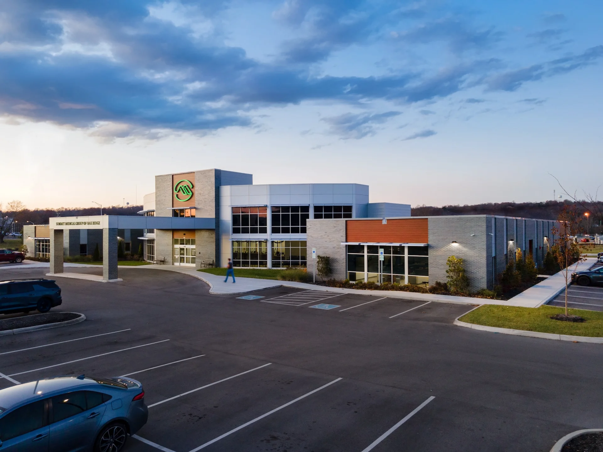 Summit Medical Group facility in Oak Ridge, Tennessee, showcasing modern architectural design by GAE Architecture + Design, featuring a welcoming entrance and landscaped surroundings, designed and built by George Ewart, a top commercial architect firm in Knoxville, TN.