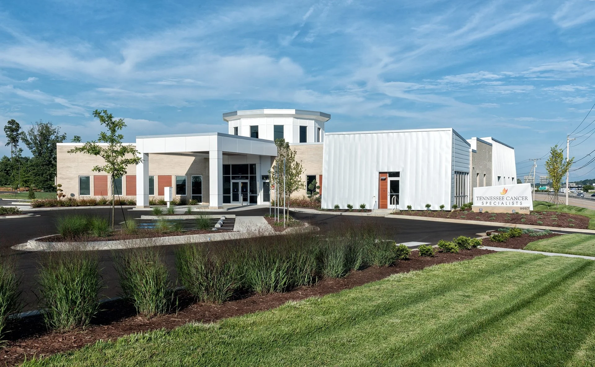 Tennessee Cancer Specialists facility in Knoxville, TN, showcasing modern architectural design, patient-centric landscaping, and signage. Designed and built by George Ewart, a top commercial architect firm in Knoxville, TN.
