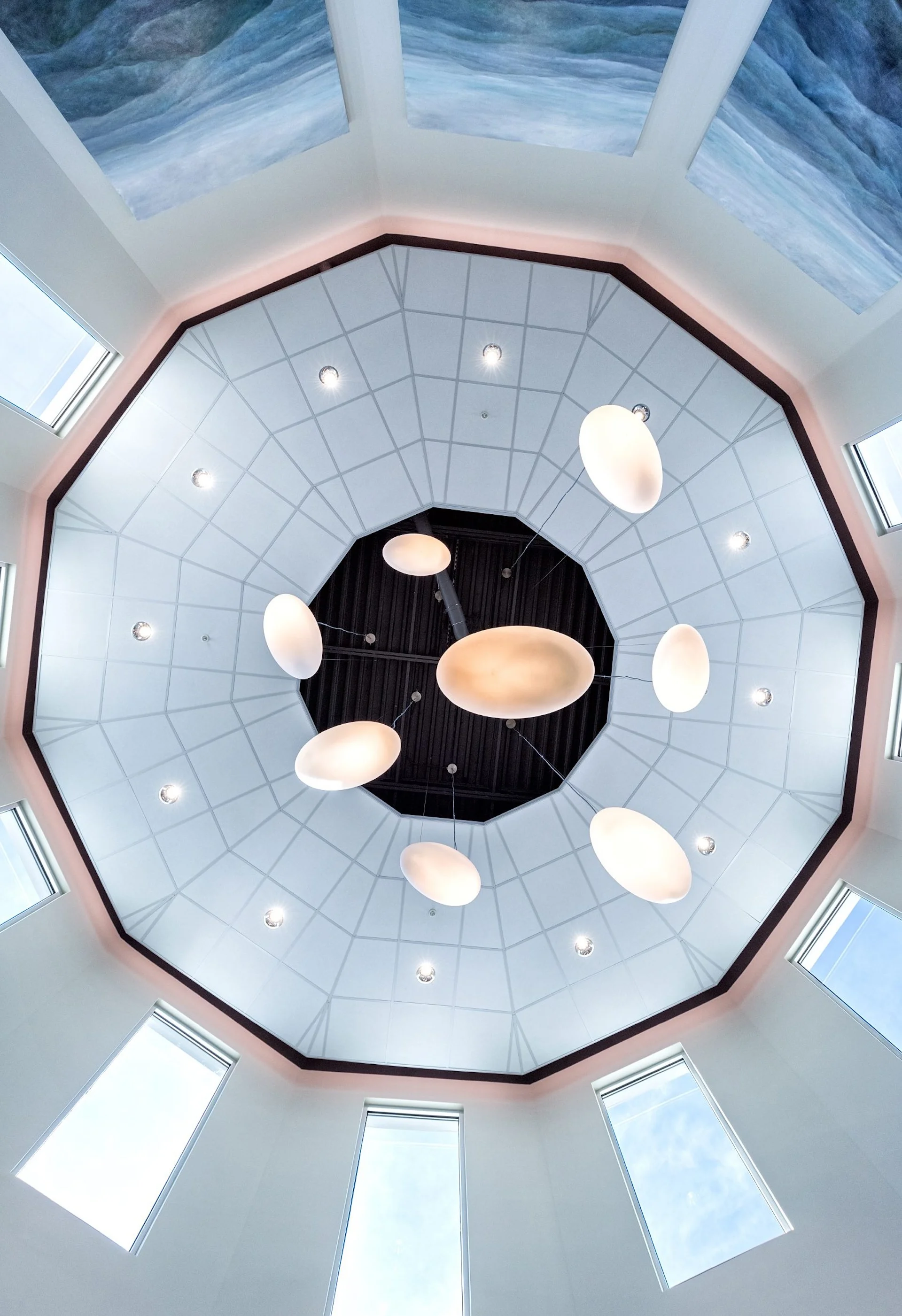 Octagonal ceiling design featuring hanging light fixtures and large windows, creating a bright and calming atmosphere in the Tennessee Cancer Specialists building, designed and built by George Ewart, a top commercial architect firm in Knoxville, TN.