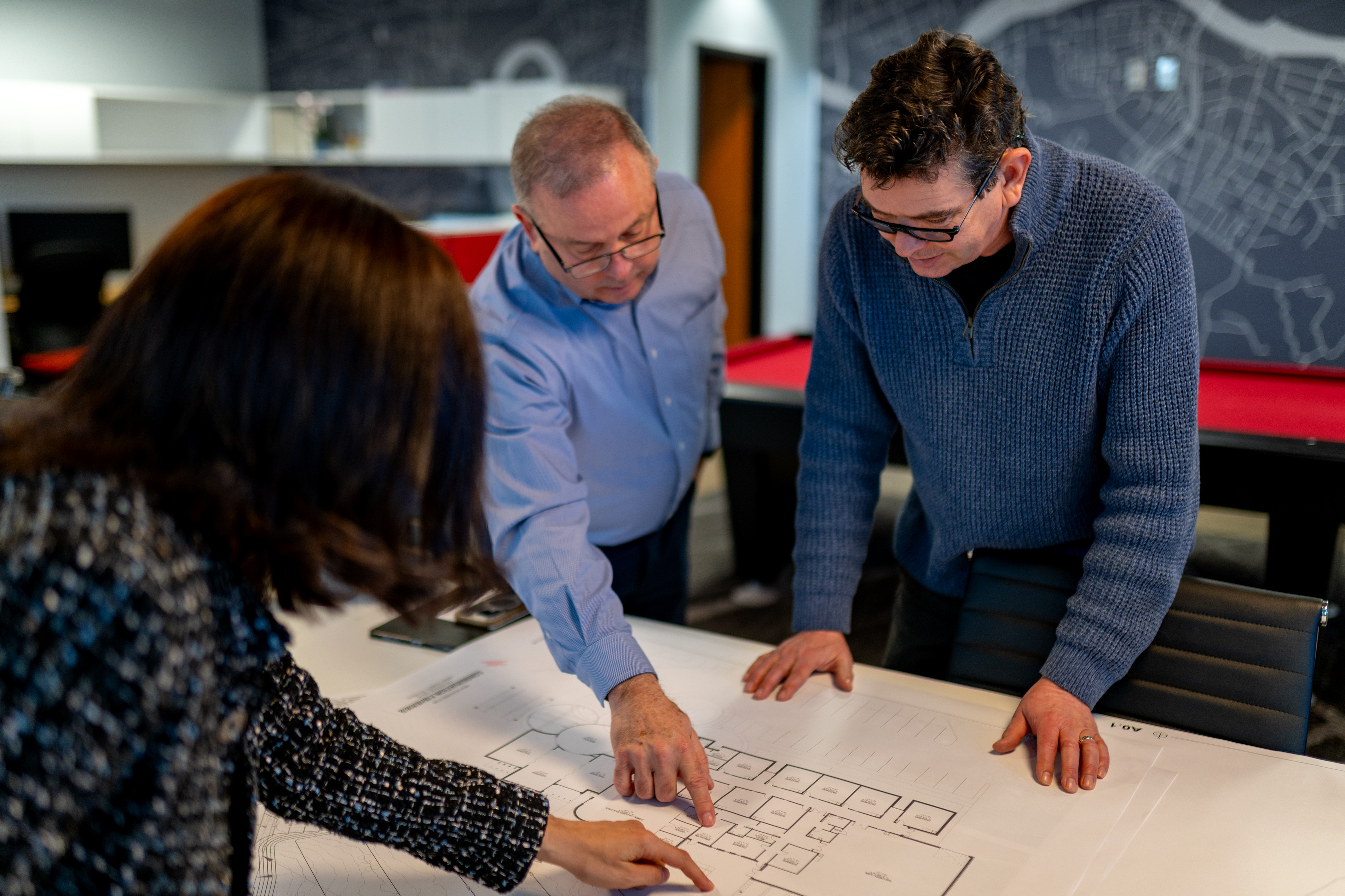 commerciala-architects-at-GAE-architecture-design-discussing-a-floor-plan